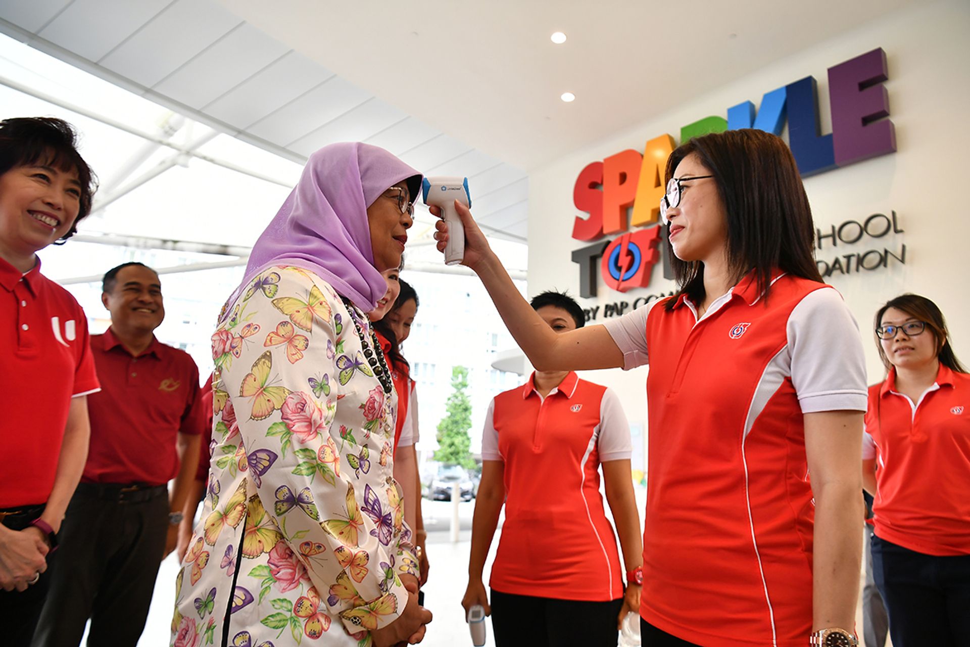 Ms Serene Yap Pei Ching, 40, lead centre principal, taking President Halimah’s temperature at the external foyer of PCF Sparkletots @ Punggol North on March 5, 2020. ST PHOTO: LIM YAOHUI
