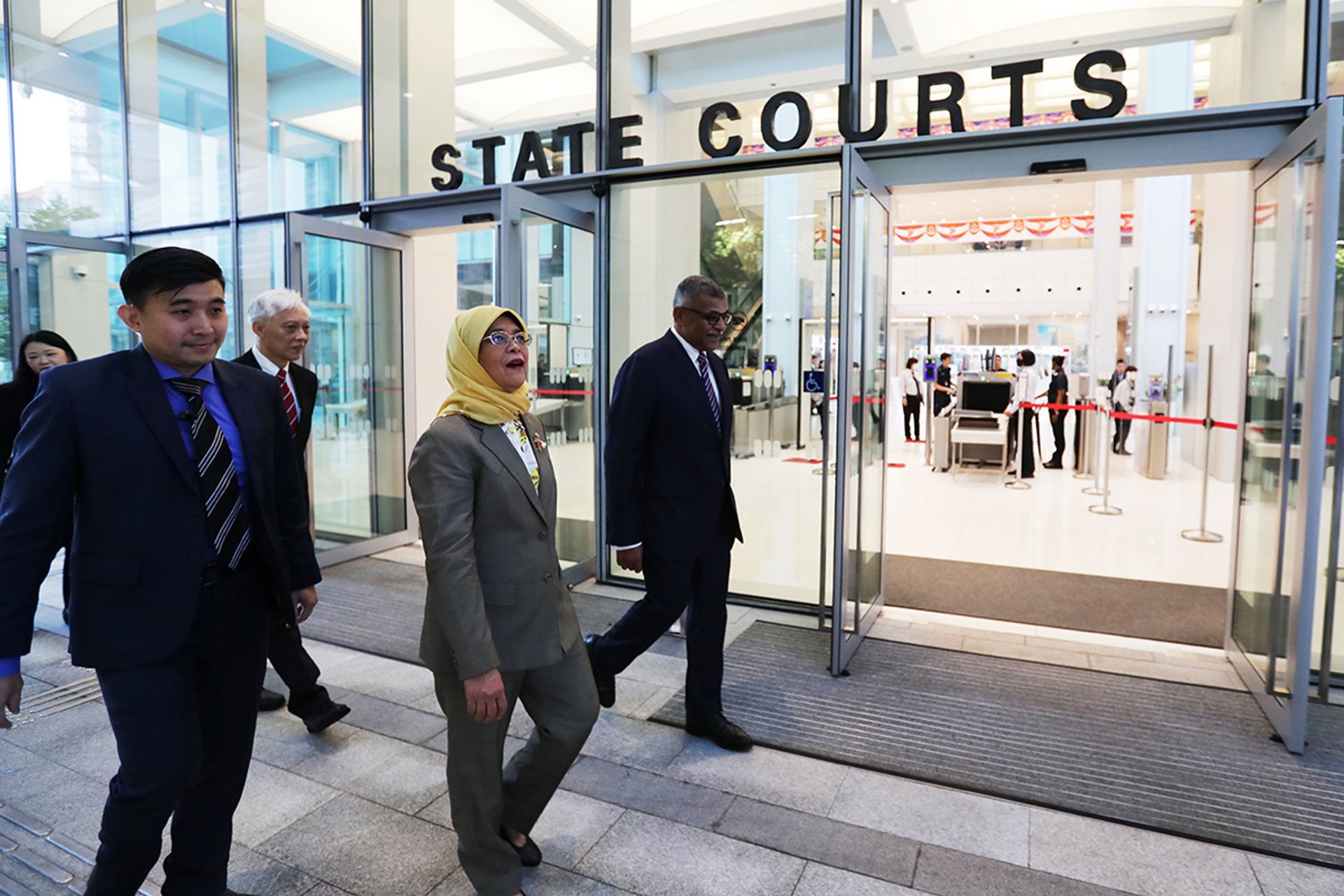 President Halimah arriving at the State Courts as the guest of honour for the official opening of the State Courts Towers, on July 1, 2023. The opening was originally scheduled for Feb 14, 2020, but was postponed twice because of the Covid-19 pandemic. Madam Halimah was accompanied by Chief Justice Sundaresh Menon (far right) and Presiding Judge of the State Courts, Justice Vincent Hoong (third from left). ST PHOTO: KELVIN CHNG