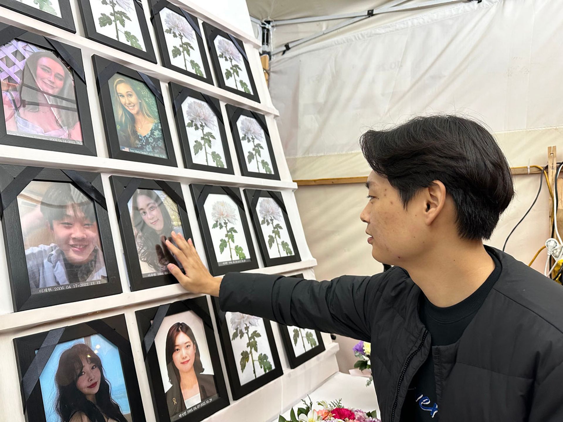 Mr Seo Byeong-woo touching a photo of his fiancee, Ms Lee Joo-young, at the memorial altar located outside Seoul City Hall. He survived the Itaewon crush, but she did not. PHOTO: WENDY TEO