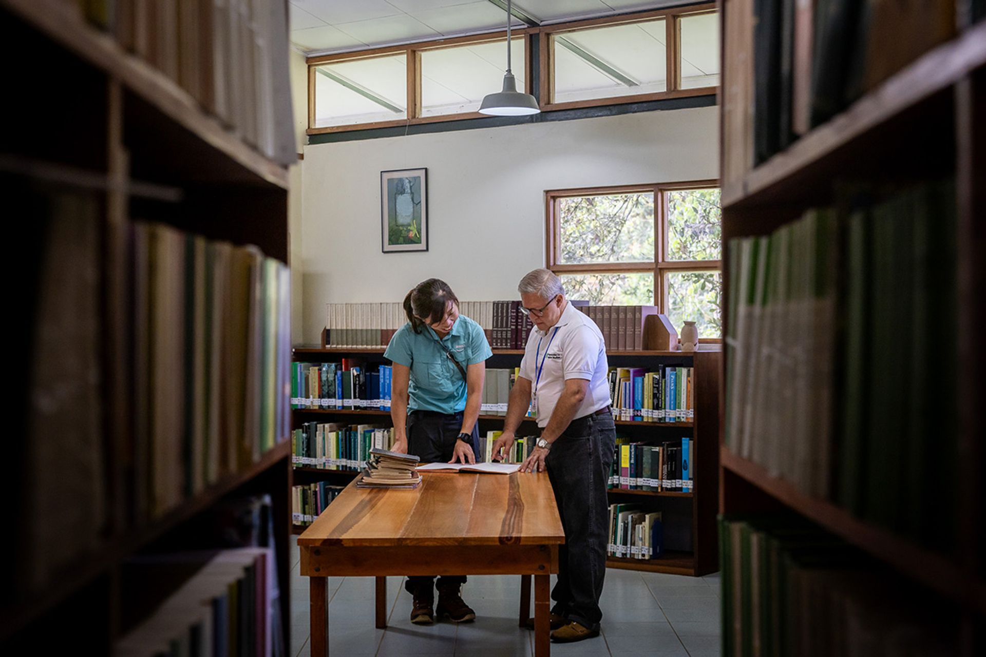 Ms Xue and Mr Rodolfo Quiros, an academic and research manager at Las Cruces Research Station and the Wilson Botanical Garden, looking through records on Oct 2, 2023 that they had uncovered during an earlier visit by Ms Xue in June. The garden, founded in 1962, was acquired in 1973 by the Organization for Tropical Studies.